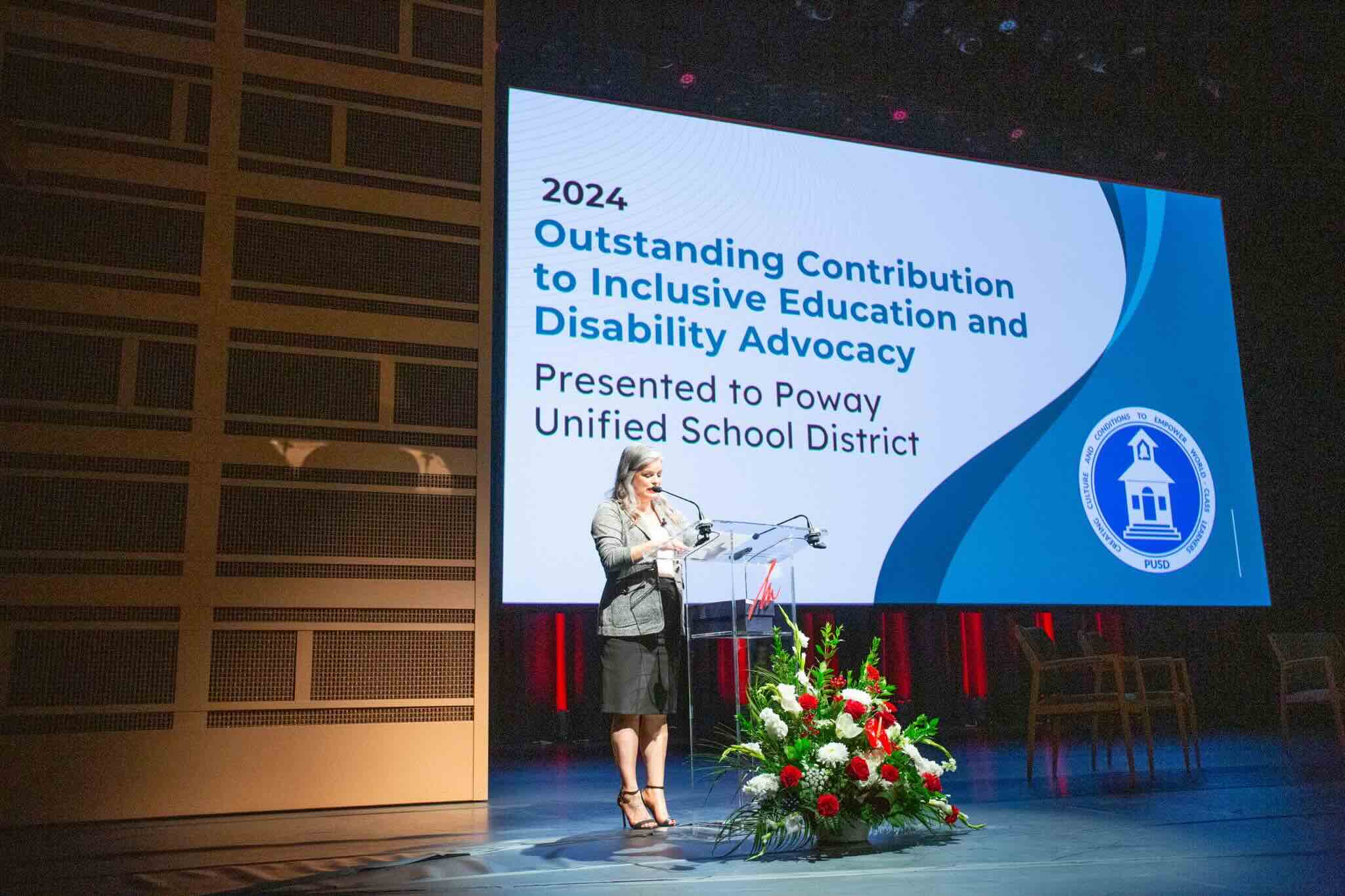 Audri M. Sandoval Gomez, Ph.D. presents an award for Outstanding Inclusive Practices.